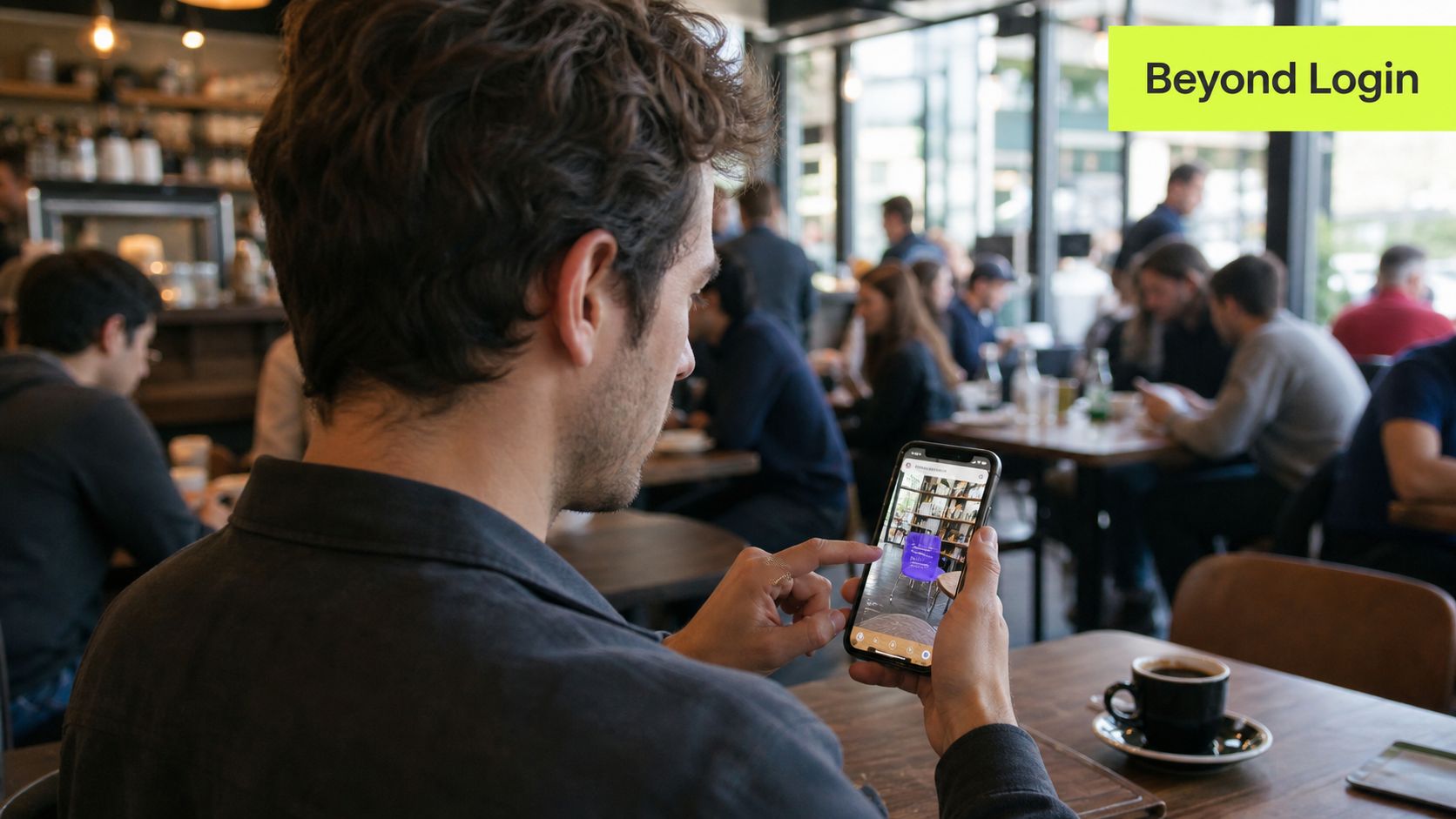 A man using a mobile phone to view augmented reality furniture in a cafe setting.